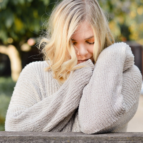 woman snuggling a sweater